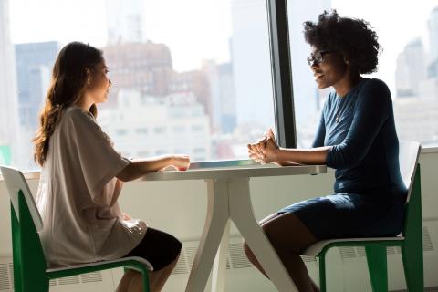 Photo of two women at a desk in an interview