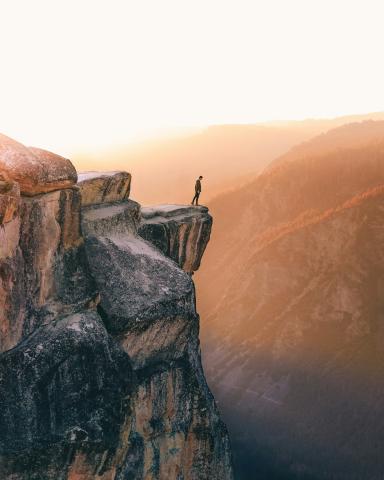 Man standing at the edge of a cliff