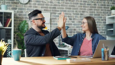 Image of two people high fiving